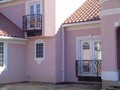 Wrought iron balcony with fabricated railing